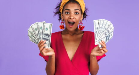 surprised-african-woman-in-dress-holding-money